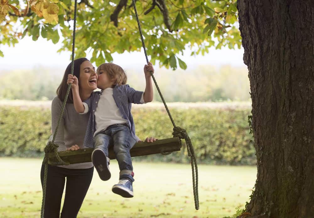 Alison with son on swing