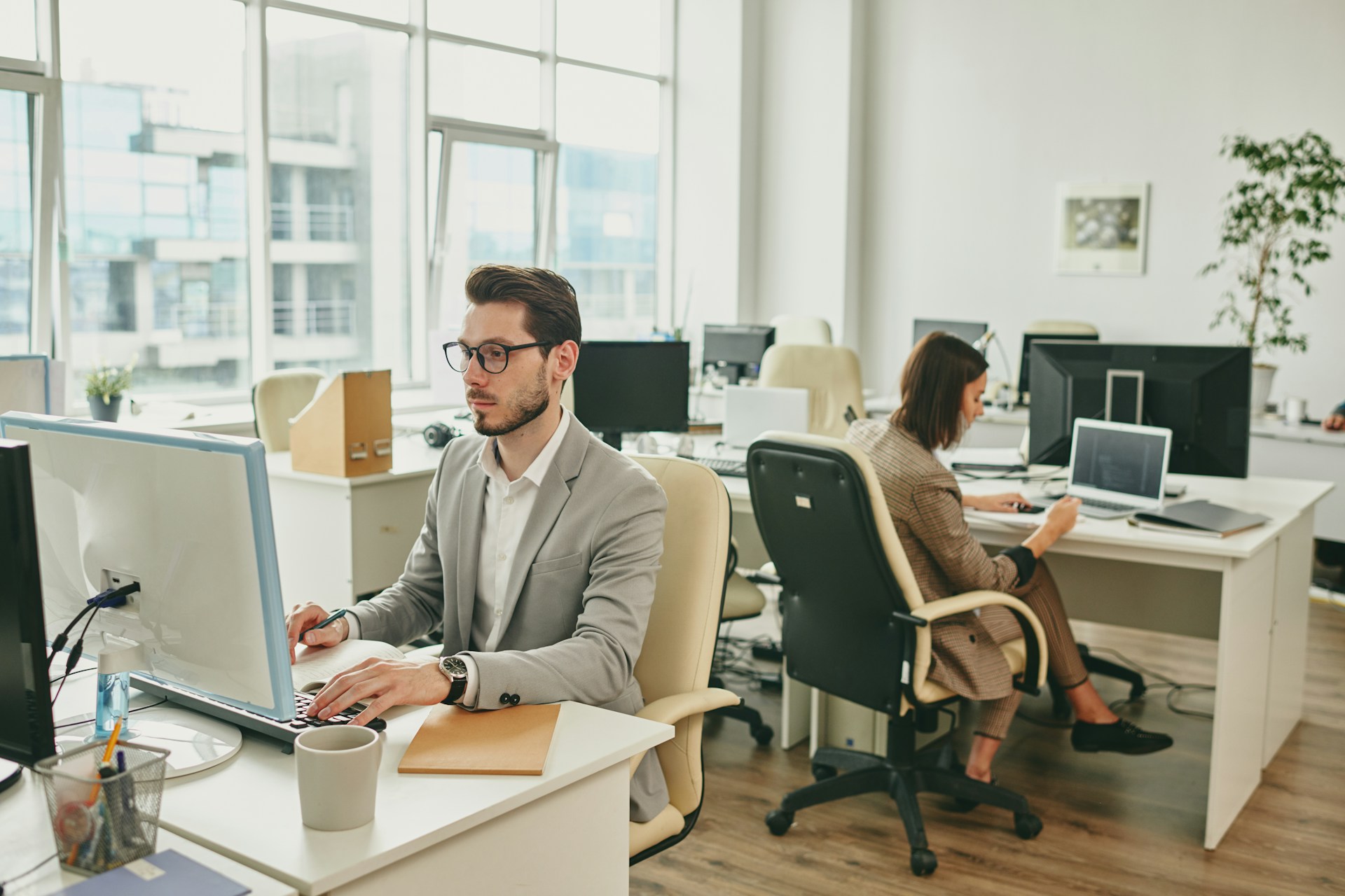 Two person sitting in front of monitor